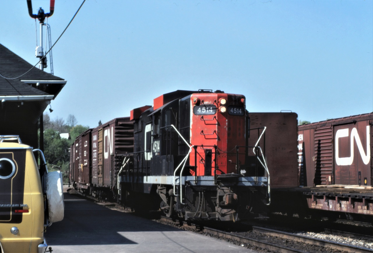 CN winterized GP9, 4514, takes a break in front of the Huntsville station on May 21, 1980.  The yard looks to be full of cars on this day.