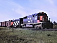 CN train 474 heads south out of Capreol with an unusual consist which includes SD40 5088, FP9A 6521, and a road repair car first up.  