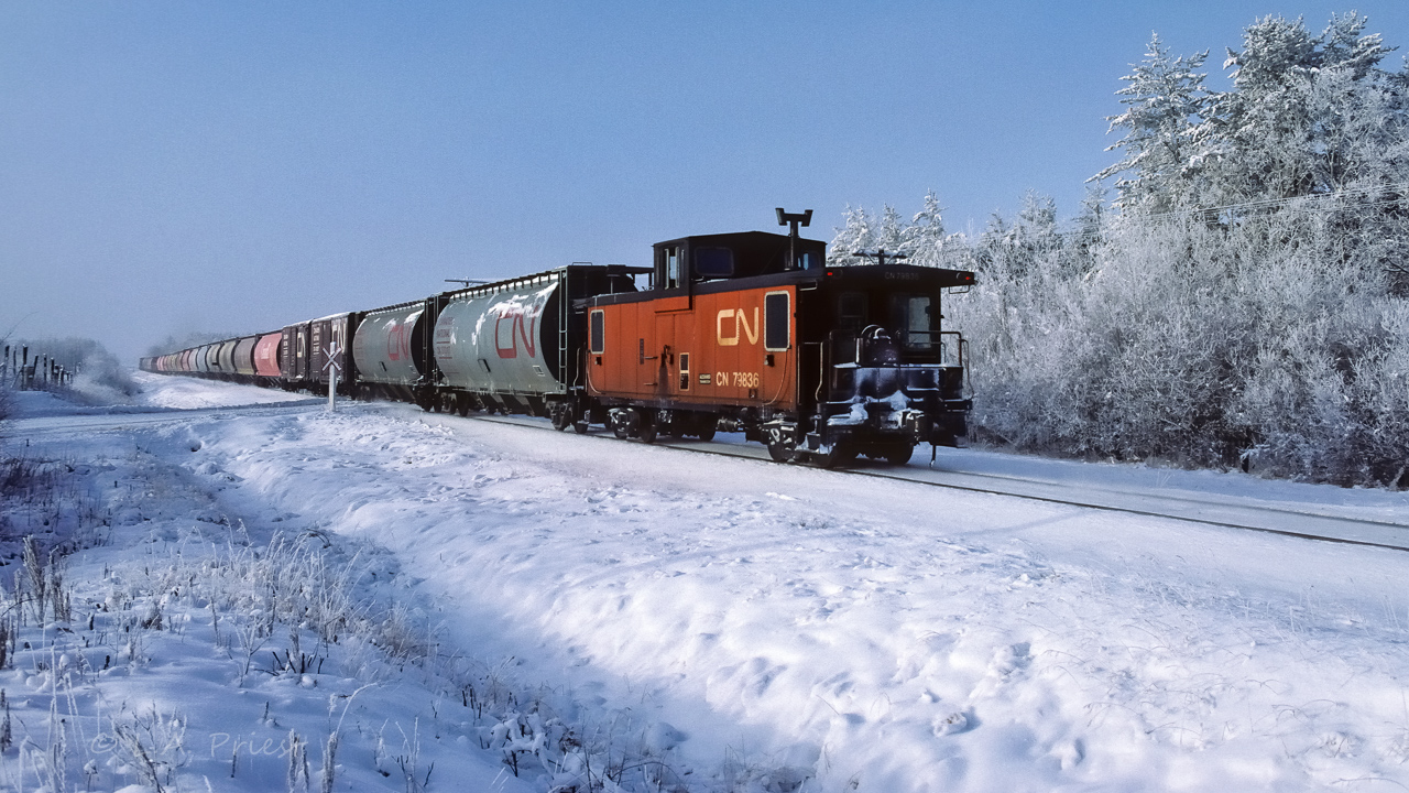 It is a frosty Saturday morning as the grain extra goes home to Edmonton. The 1065, 1069 and 4606 were up at the front. Photo taken at mile 23.8, time was 10:30.