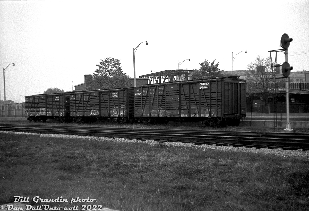 Not something you'd see at West Toronto today - stock cars! A cut of CN stock cars including cars 810245 and 810029 sit on CN storage track J105 off CN's Weston Sub, just north of the CN-CP West Toronto diamonds (note the southbound CN signals). White staining on their flanks was from lime used as a disinfectant to clean them.

A steady stream of these 40' stock cars handled livestock traffic into the nearby Ontario Stockyards and packing plants for decades until livestock shifted to trucks in the 80's, and many of the old meat processing and packaging facilities in "The Junction" closed or moved. In the background, one can see the ramp and bridge for Old Weston Road that once crossed over the CP Galt and North Toronto Subdivision tracks (demolished sometime after the bridge was closed to vehicle traffic). The West Toronto Pumping Station just behind the cars is the only thing unchanged in this photo today, unaffected by the grade separation project.

Bill Grandin photo, Dan Dell'Unto collection negative.
