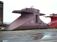 Something rarely seen.  Only four of these double-ended snowplows were ever built for CN. Transcona Shop in Winnipeg constructed them back in 1939. They were numbered 55696 to 55699. The purpose of this design was for snow clearing on branchlines where there was no place to turn the train, so the power just ran around the plow  and the snow clearing equipment just headed back the way it came. I'm not sure where they were stationed, but a good bet would be on Prince Edward Island, where I found this one in a storage line at Charlottetown. It was the last survivor, and eventually ended up at the Salem and Hillsborough Railroad (SHRR) in Hillsborough New Brunswick, where it received some restoration and was repainted and lettered "S&H".