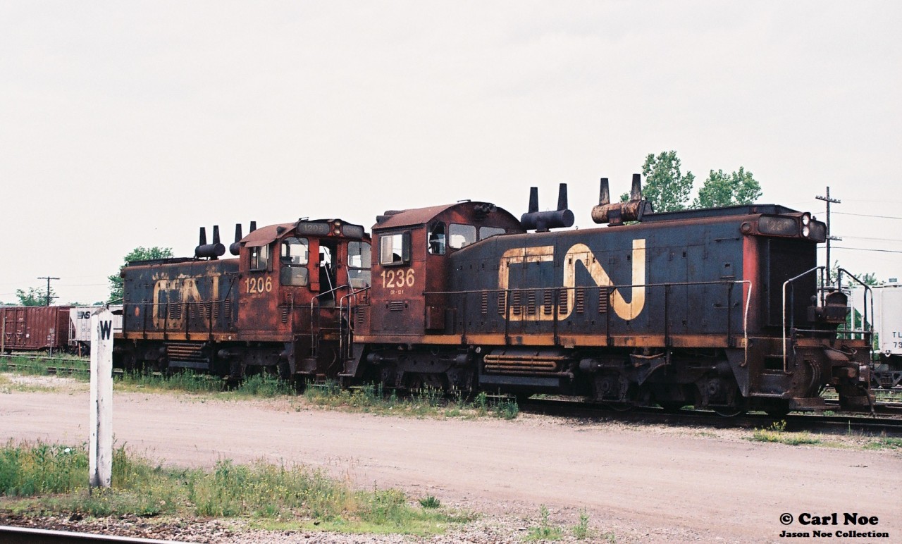 CN SW1200RS’s 1236 and 1206 are viewed outside the CN Sarnia, Ontario diesel facility during a hot and hazy summer day. According to the 1993 Canadian Trackside Guide, both units were part of a small fleet of SW1200RS’s still assigned to Sarnia.