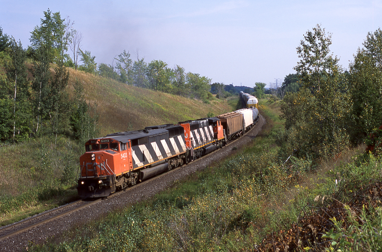 CN#396 with the 5403 and 5265 is seen grinding upgrade through the most scenic portion of the Halton Sub just north of Milton.  This was certainly a nice spot to watch the afternoon parade of eastbounds headed for Mac Yard.