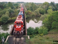 During a late summer evening, CP train 271 slowly departs the west siding switch Coakley in Woodstock on the Galt Subdivision with SD40-2 5420 leading a lengthy consist after meeting an eastbound. 
<BR> 
CP 5420 is former Kansas City Southern Railroad 675 and it would go on to enjoy a long second life on CP. 
