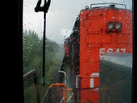 The view looking forward from the trailing GEC Alsthom unit as we head eastbound into some heavy rain on the Caramat Sub. with the CN 5647 leading. Note - Exact location approximate, somewhere east of Longlac. 