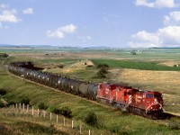 Southbound from Moose Jaw to Assiniboia with empty tank cars for crude loadouts on Great Western Railroad nears the top of the Missouri Coteau ridge. The coteau which stretches from Southeast South Dakota to the North Saskatchewan river north of Lloydminster and is the defining line between the tall grass prairie and the semi arid short grass plains