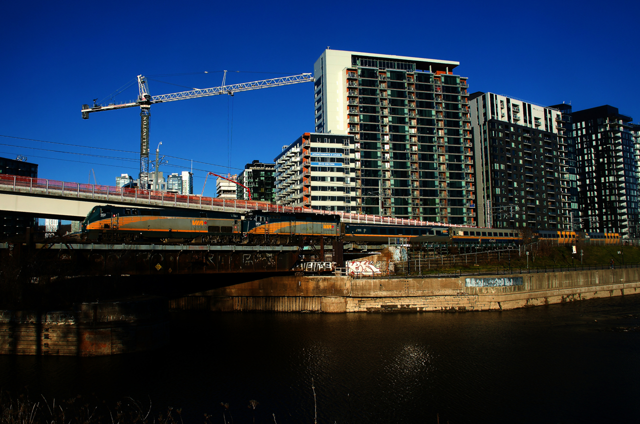 VIA 63 uncommonly has two units up front (both unwrapped) as it passes the Peel Basin with VIA 902, VIA 6404 and four LRC cars.