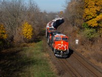 On one of or if not their first revenue run, a pair of rebuilt CN AC44C6M's navigate the S curves through the town of Paris with 396's train in tow. 