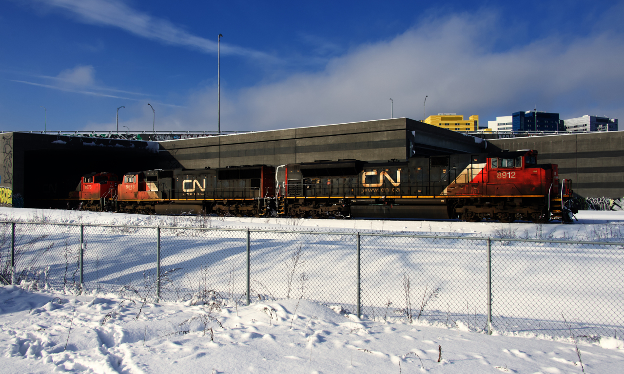 CN 120 emerges from underneath the Turcot Interchange with an EMD trio up front (CN 8912, CN 5653 & CN 8873) and a fourth EMD unit mid-train (CN 8888).
