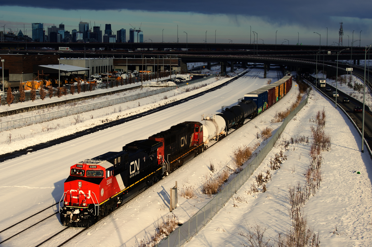 The sun stays out just long enough to get a well-lit shot of CN 305 passing the skyline of downtwon Montreal with class leader CN 3300 leading. CN 3300 was rebuilt from Dash9 CN 2641 and has been in service a bit under two months now.