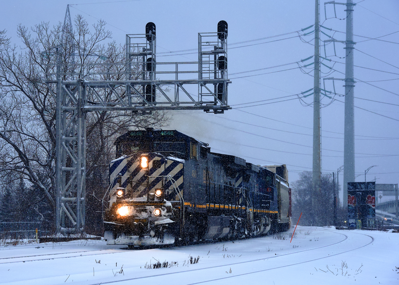 CN 527 has matching BCOL units (BCOL 4646 & BCOL 4653) as it heads towards Taschereau Yard as thick snow falls after lifting two cars at Pointe St-Charles Yard.
