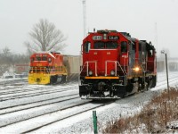 CN L540 with GTW 5849 and CN 7515 slowly cruise down the Guelph Subdivision passing the Kitchener yard with Goderich-Exeter Railway’s newest unit, GEXR GP38-2 3523 looking on during a winter storm. L540 would eventually reverse into the yard, as the crew would be ready to end their shift ahead of Christmas. 

