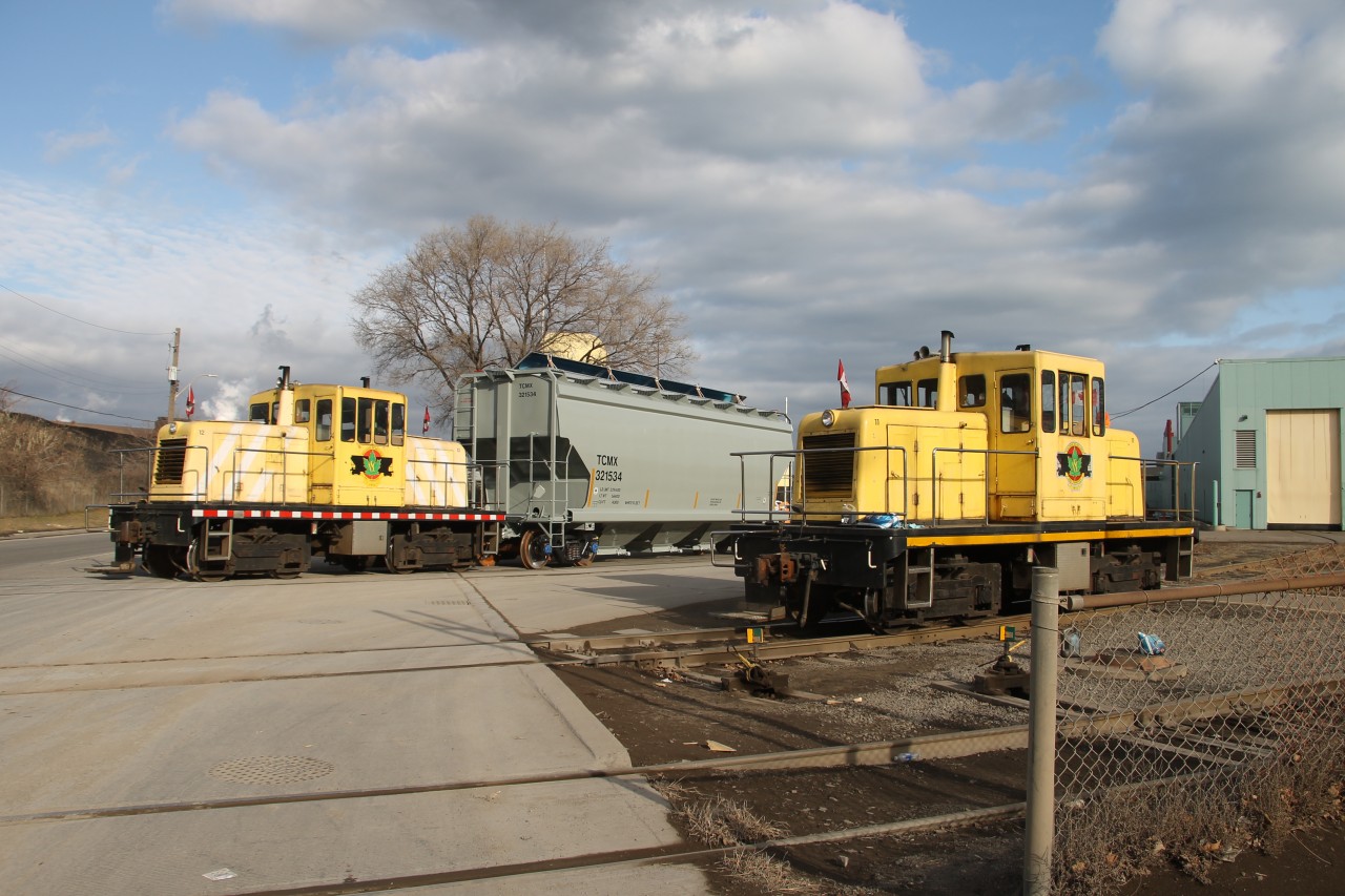 NSCX 12 makes a reverse move with TCMX 321534 while NSCX 11 makes a light engine move into the yard at National Steel Car.
