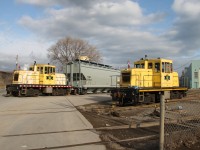 NSCX 12 makes a reverse move with TCMX 321534 while NSCX 11 makes a light engine move into the yard at National Steel Car. 