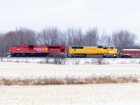 A good trip gone bad. UP 4066 wasn't feeling well, and 135 stalled on the climb to Campbellville. The decision was made to double the hill. So after about 4 hours, 7028 is doing most of the work dragging 10000 tons at about 25mph as Orr's lake Hill's .9% grade looms. Happily, for what must be an exhausted crew(yes, they did get a lift from a road foreman to save some walking, but so many hand brakes to tie on...and then take off), they made it up the hill out of the Grand River Valley, and all the way to London....where 7028 decided it was finished doing all the hard work and was rumoured to have a computer "meltdown" that put the rain in emergency...with no way to recover. Some days just go that way.....