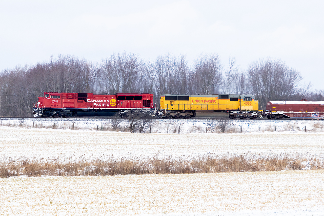 A good trip gone bad. UP 4066 wasn't feeling well, and 135 stalled on the climb to Campbellville. The decision was made to double the hill. So after about 4 hours, 7028 is doing most of the work dragging 10000 tons at about 25mph as Orr's lake Hill's .9% grade looms. Happily, for what must be an exhausted crew(yes, they did get a lift from a road foreman to save some walking, but so many hand brakes to tie on...and then take off), they made it up the hill out of the Grand River Valley, and all the way to London....where 7028 decided it was finished doing all the hard work and was rumoured to have a computer "meltdown" that put the rain in emergency...with no way to recover. Some days just go that way.....