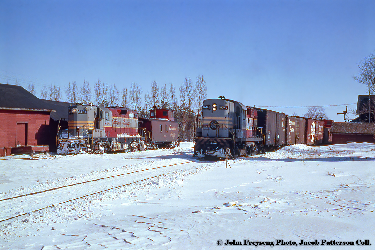 Canadian Pacific train 91, the Teeswater Sub wayfreight out of Orangeville, passes through Grand Valley with three boxcars and one of CP's early steel, end cupola vans (437268 - 437404 series) bringing up the rear. On the siding at left, plow extra 8424 sits uncoupled from its plow alongside Tindall Feeds.CP 8742, rebuilt to CP 1815, would survive into Ottawa Central days until the OC was purchased by the CN. 8242, rebuilt to 1505, would be scrapped in 2011.John Freyseng Photo, Jacob Patterson Collection Slide.