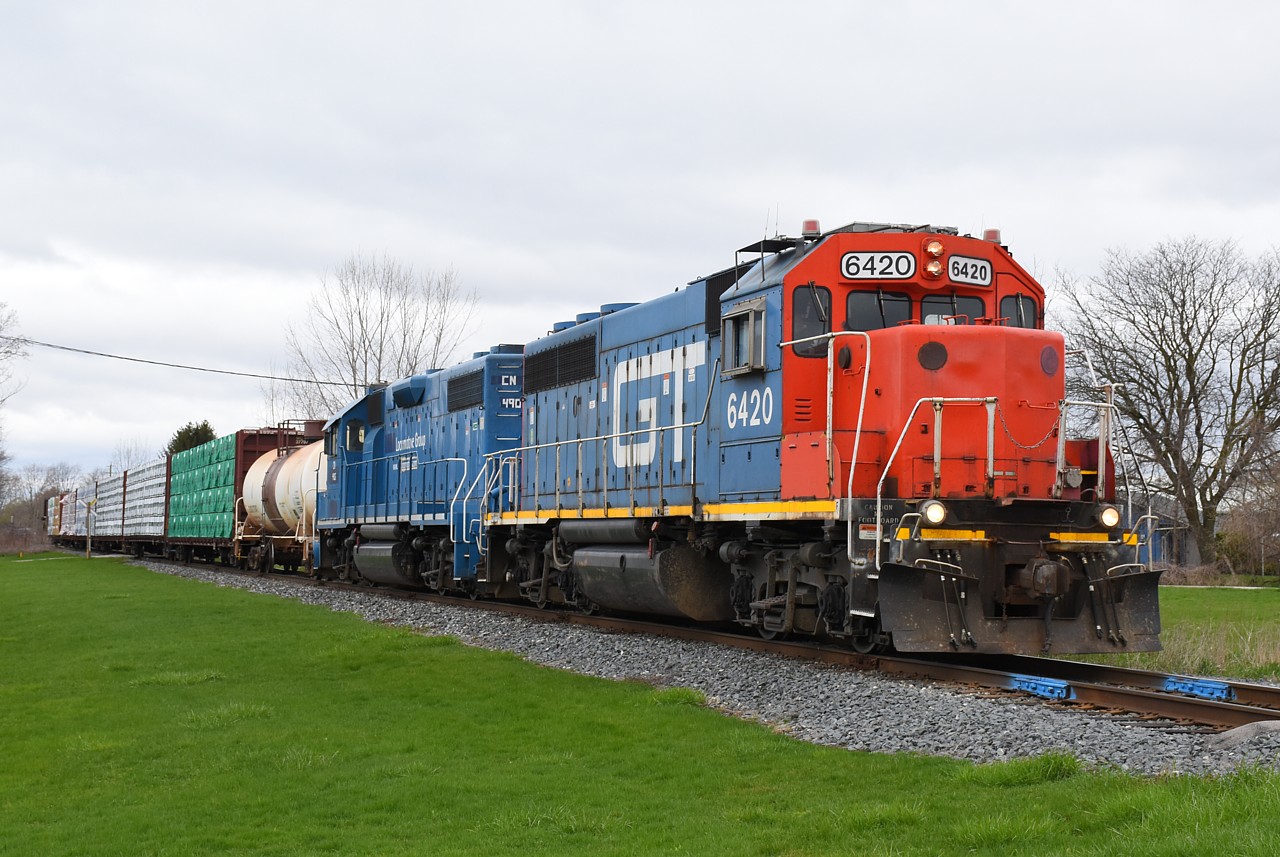 Some locomotive consists last for months on CN 580, while others do not.  Naturally, this colourful duo only lasted two days!  They worked around Brantford on this Wednesday, ran to Caledonia and Hagersville on Thursday, and I think that was it. They were quickly replaced by GTW 6425 (in CN paint) and CN 4798, which of course hung around in Brantford a lot longer.  One day 1 of 2, CN 580 is shown in Cainsville with one tank car for Blastech to be relined, and six loads of lumber to be unloaded at Rembos.