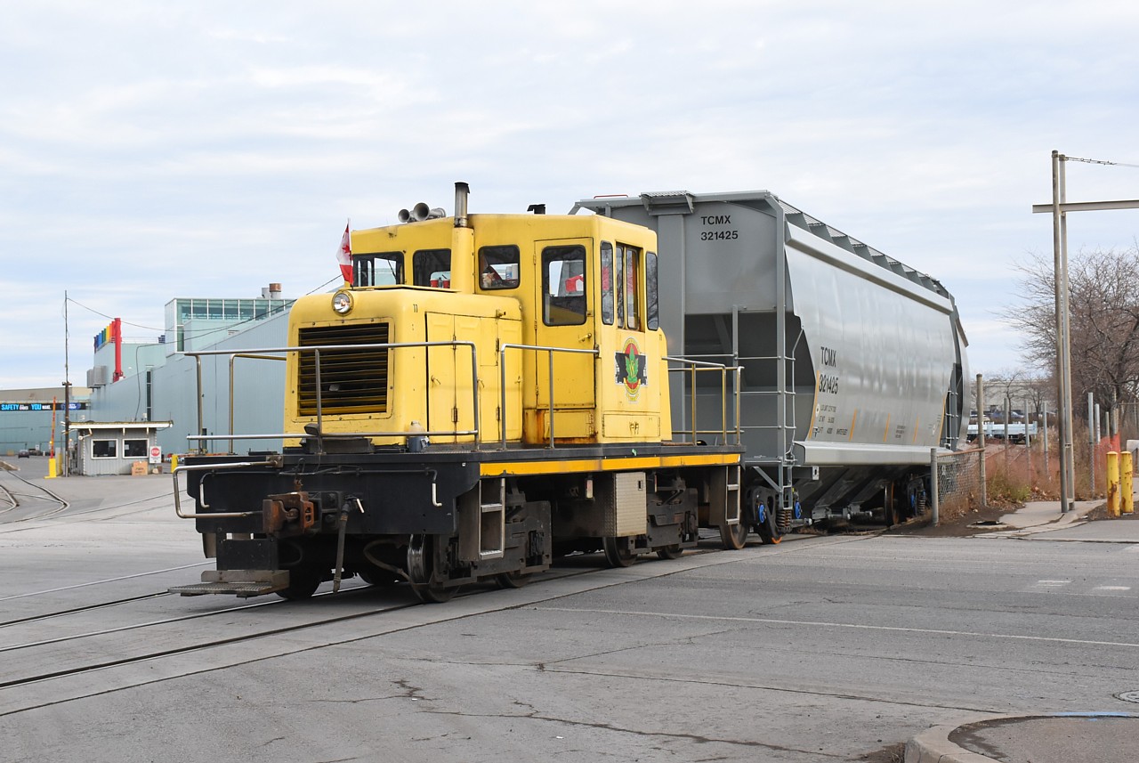 The Donut Stop on Parkdale Avenue was calling to me, so on my day off today I paid them a visit.  Since I was in the north end anyway, I too was curious to see if one of the Korean SW1001s was working at National Steel Car.  Kenilworth Avenue North parallels National Steel Car's property, but it's busy with trucks going in and out of Dofasco.  The switchers may have still been parked where Steve caught them yesterday, but it was tough to see and today there was several rows of new rail cars parked in the way.  NSC 11 was bombing around switching cars around their yard as it often does, so at least I was able to get a decent photo of it.  And I got donuts, so I can't complain.