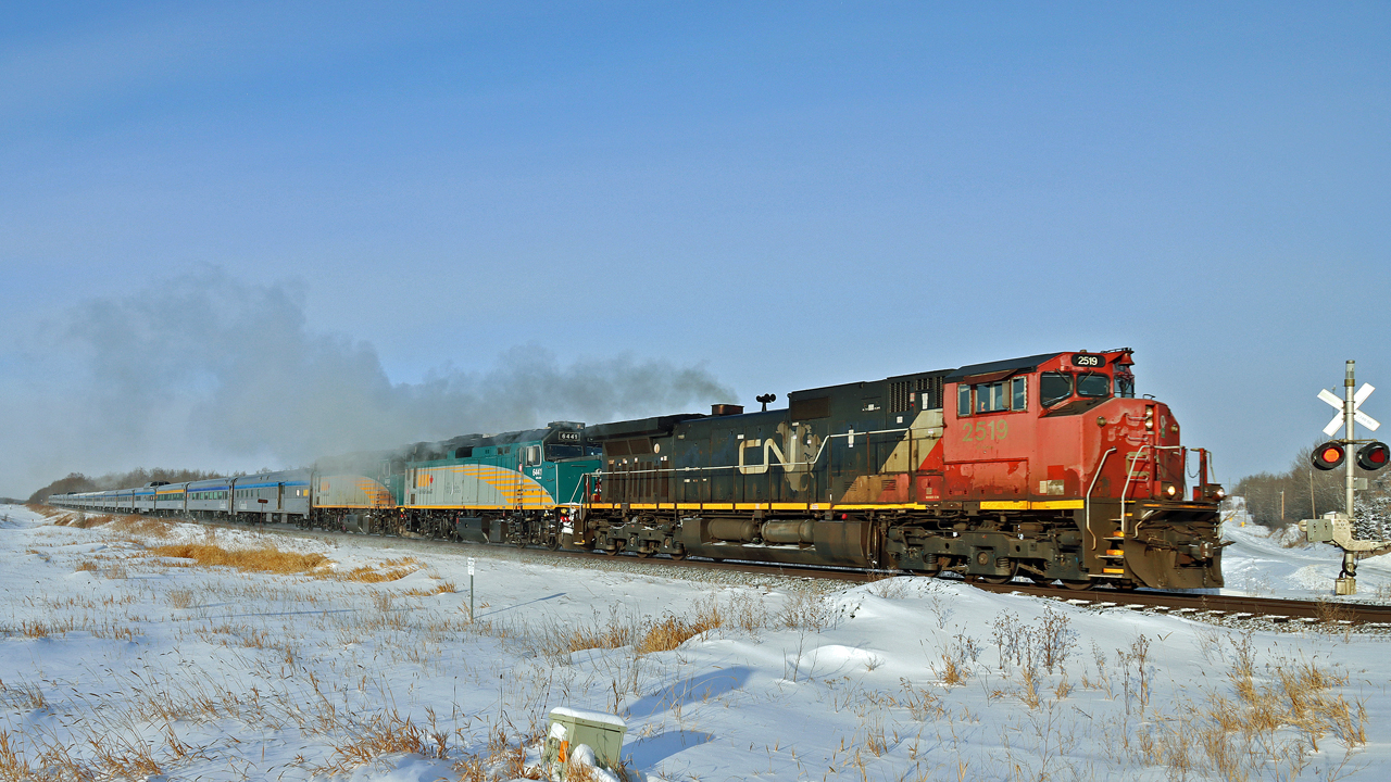 A very late running ( 15/16 hours) VIA #2 is heading east on the Wainwright Sub at North Cooking Lake with the assistance of CN 2519. Reportedly one of the HEP units on the VIA locomotives had failed.  The joys of winter operations, at the time of this shot -30C on thermometer, -40C windchill.