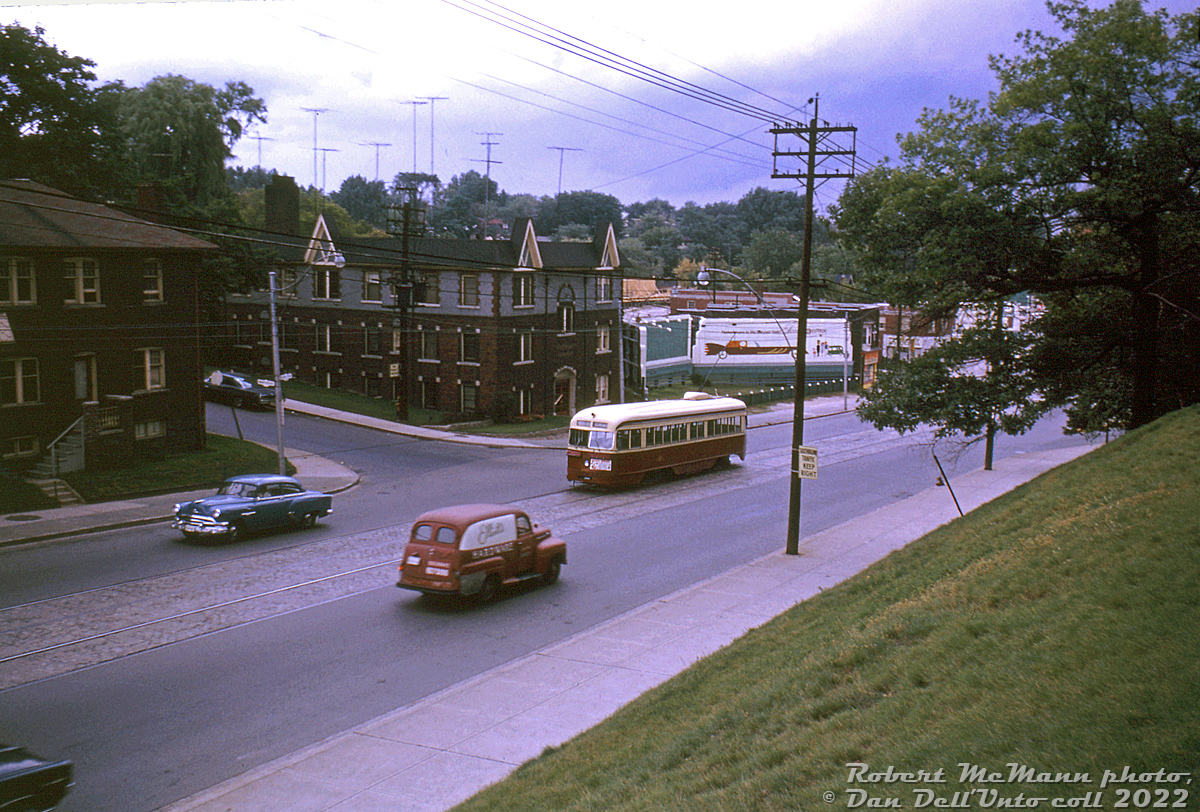 TTC PCC 4115 (part of the original 4000-4139 A1-class PCC order, built by CC&F in 1938) climbs the grade up Bloor Street West at Mountview Avenue, just west of Keele, in August 1964. Construction on the original Bloor-Danforth subway line is well underway, marked in this photo by wood constuction scaffolding at Keele Subway station visible in the distance. This portion of the Bloor streetcar line (Keele to Jane Loop) would surive the initial Keele to Warden B-D subway opening in February 1966, but service would be discontinued in May 1968 and the tracks removed after the western extension to Islington station opened.

Robert D. McMann photo, Dan Dell'Unto collection slide.
