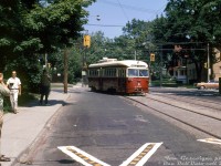 There's no shortage of cameras and Kodachrome out on this sunny day: fantrip attendees photograph TTC PCC 4589 taking the curve from southbound Mount Pleasant Avenue to westbound St. Clair Avenue East, during what was probably a farewell charter for the TTC's group of secondhand A10-class ex-Cincinnati PCC streetcars (TTC 4575-4601, built 1939-40). There's even one dedicated fellow with a smoke in hand while taking his photo.<br><br>Most of this series of streetcars were retired and shipped off to Egypt in the mid-late 1960's (they became redundant due to the Bloor-Danforth subway opening in 1966 and extension in 1968), but a few A10's like 4589 hung on into the early 70's until being retired (4589 was one of ten PCC's later sold to Tampico, Mexico, where it did run for a time). Streetcar service on Mount Pleasant wasn't far behind - despite TTC's early 70's decision to not scrap its streetcar network as previously planned, service on Mount Pleasant ended in late July 1976 and was replaced by trolleybuses.<br><br><i>Tom Gascoigne photo, Dan Dell'Unto collection slide.</i>