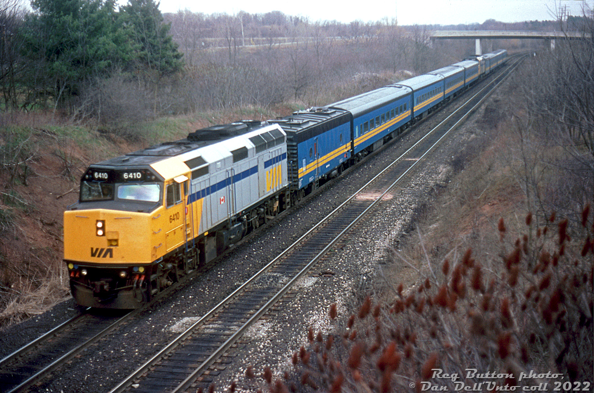 Hustling westbound up the CN Dundas Sub at Mile 1, VIA F40PH-2 6410 leads a "J-train" of combined trains #77 and #51 (with 6417 tucked in halfway back), with no shortage of old blue and yellow ex-CN passenger cars trailing. Since the cars were steam-heated and the "new"(ish) F40's were HEP, ex-CN steam generator cars were needed to keep things warm onboard.

This photo was taken during the defective axle debacle that plagued VIA's LRC fleet and took it out of service at the time, necessitating a scramble to press old and borrowed equipment (notably some GO consists) into VIA service to pick up the slack. This included the old blue & yellow fleet, that VIA had opted not to upgrade/modernize with HEP after the 1990 VIA cuts and instead decided to retire and sell off.

Reg Button photo, Dan Dell'Unto collection side.