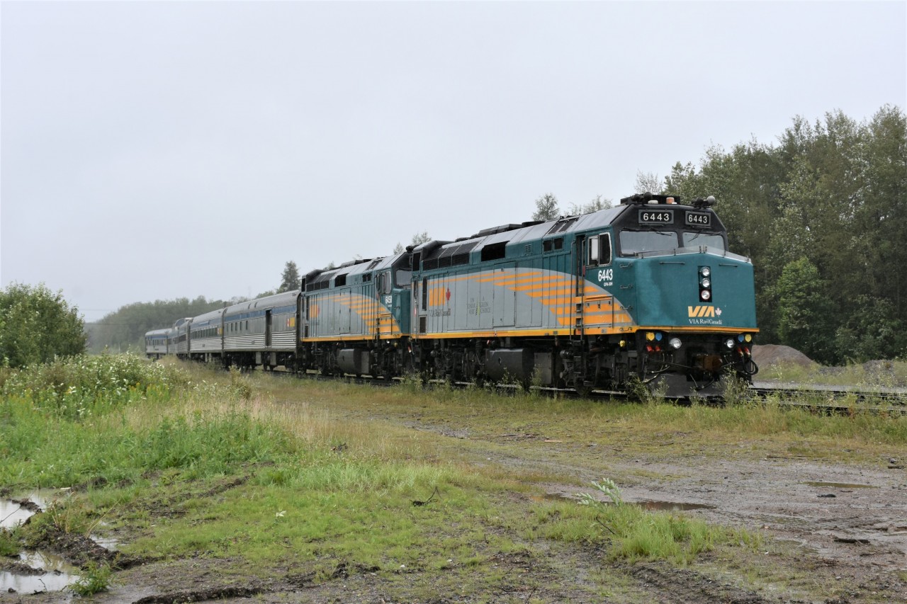 VIA 693 (Winnipeg to Churchill) with VIA 6443 & VIA 6458 for power sits on the station track with its tail end cars zig-zagged across yard tracks on this rainy afternoon in Thompson, MB. Meanwhile, about one car length ahead, VIA 692 (Churchill to Winnipeg) is occupying the platform area in front of the VIA station. Both trains had met at the wye switches on the Thicket Sub. and backed up the line to the station one behind the other. Just one of many unique experiences encountered on my week-long trip from Winnipeg to Churchill and return. I'm sure glad I made this trip before VIA added the 'buffer car' to the tail end!