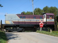 Following an extended hiatus due to the global pandemic, the first regular revenue Waterloo-Central Railway train to operate in over two years is viewed crossing Township Road 24 just north of the village of St. Jacobs, Ontario with S13 1002 leading towards Elmira.

