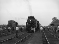 Canadian National ran excursions behind their 4-8-4 class U-2-e steam locomotive CN 6167 from 1960 until 1964.<br>
Here is 6167 at the furthest stop of the Toronto Union to South Parry (and return) excursion of 10 June 1962. <br><br>
Details more evident at full size include 2 boys climbing the cab steps, and a crewman in overalls on the platform.<br><br>
CN 6167 was built by Montreal Locomotive Works in March 1940, working in freight and passenger train  service with CN until 1959.<br>  
Its most dramatic day was 6 July 1943 when it was seriously damaged in a tragic fatal collision.<br>
If not for the wartime conditions, 6167 would likely have been scrapped rather than repaired. <br> <br>
Reactivated for excursions in 1960, its last run was September 28, 1964.  CN 6167 was donated to Guelph in 1967. <br><br>
For more information:<br>
https://www.ghra.ca/railway-history/canadian-national-railway-6167/
