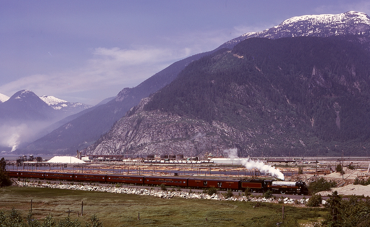 On the first day, Tuesday 1974-06-18, that former CP Royal Hudson 2860 made a trip on the British Columbia Railway from North Vancouver to Squamish, here she and her train are northbound under the watchful eye of ~1700-metre (~5660 feet) Mount Murchison, with the Squamish docks in the background and the Woodfibre pulp mill in the distance on the far left.