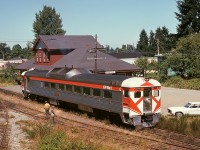 Just getting underway for its 139-mile run back to home base at Victoria, Budd/CC&F RDC-2 9199 is leaving the depot at Courtenay on Friday 1974-08-02, on time at 1300 PDT, in a view from the top of a boxcar spotted on the spur as seen on the left.