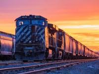 After a Dauphin crew built the train, a Winnipeg crew hops on to take it south. As the conductor and trainee take off handbrakes the engineer sets up the units for the late evening departure.