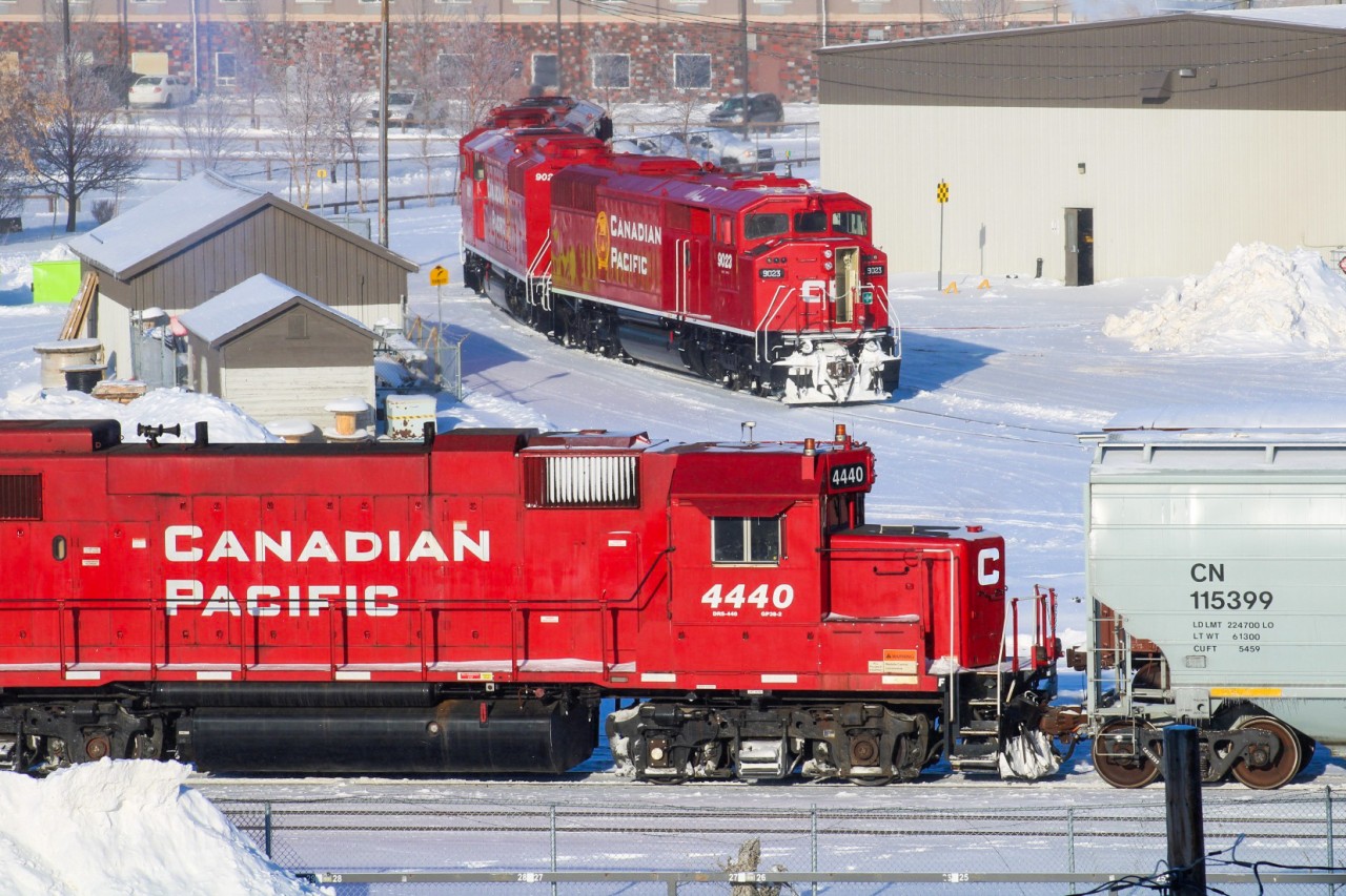 Of all places to be shooting trains in my home turf of Regina, the Cornwall Centre Mall Parkade is purely an unorthodox approach, with no potential view of east or west. With time to kill before E07 would make it's run north to Cupar, I got wind of the fact that they were being asked by the ATM to reverse up the wye a few hundred feet on the CN Regina Terminal lead to allow 0630 Yard into F Yard. Remembering my last visit to the parkade years ago, I made a dash up the stairs to acquire this "bird's eye view" of the wye. My preferred unit of choice from the yard job power was the 4440, framed here bypassing E07.