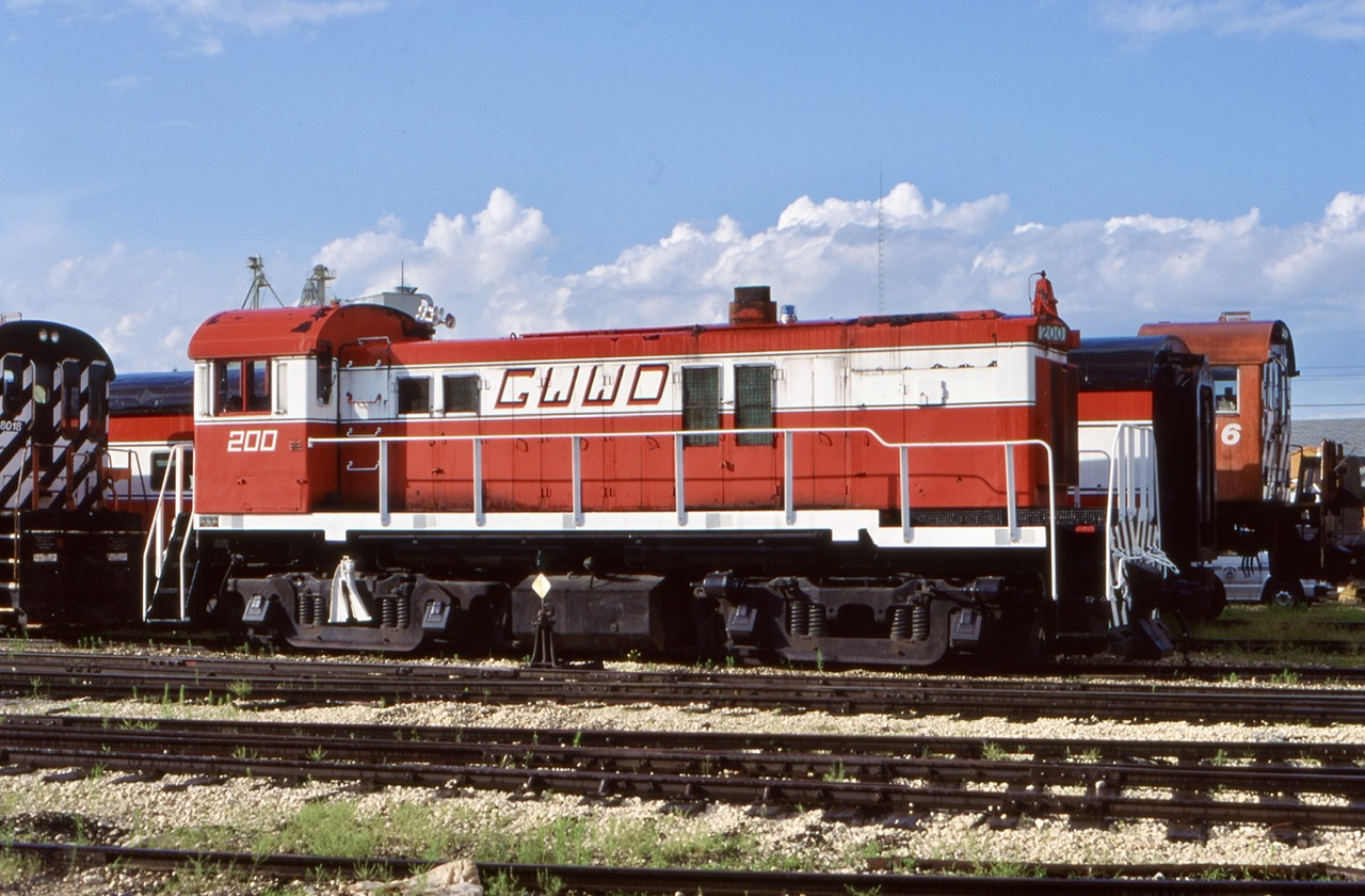 Far from its original home on the Sydney & Louisburg Railway. GWWD 200, a RS23 awaits its next assignment in the yard in Winnipeg. A pair of former CP RS23’s can also be seen in this frame gradually being used as a parts source.