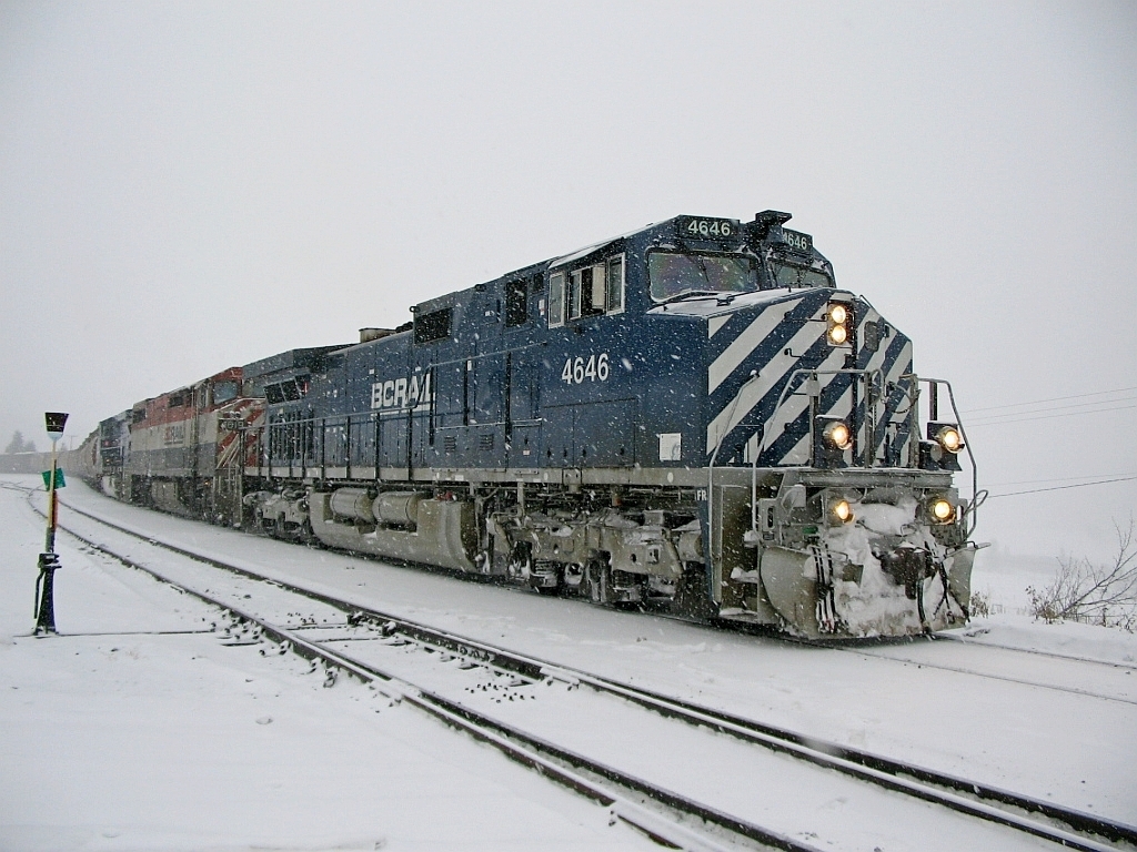 A drab winter morning at Exeter on BC Rail Lillooet sub. We were making a pickup at Exeter and would continue south to Potter siding and change off with another crew "meet & greet" and run back north to Williams Lake BC. It was a dull snowy morning, image taken at 10:37.