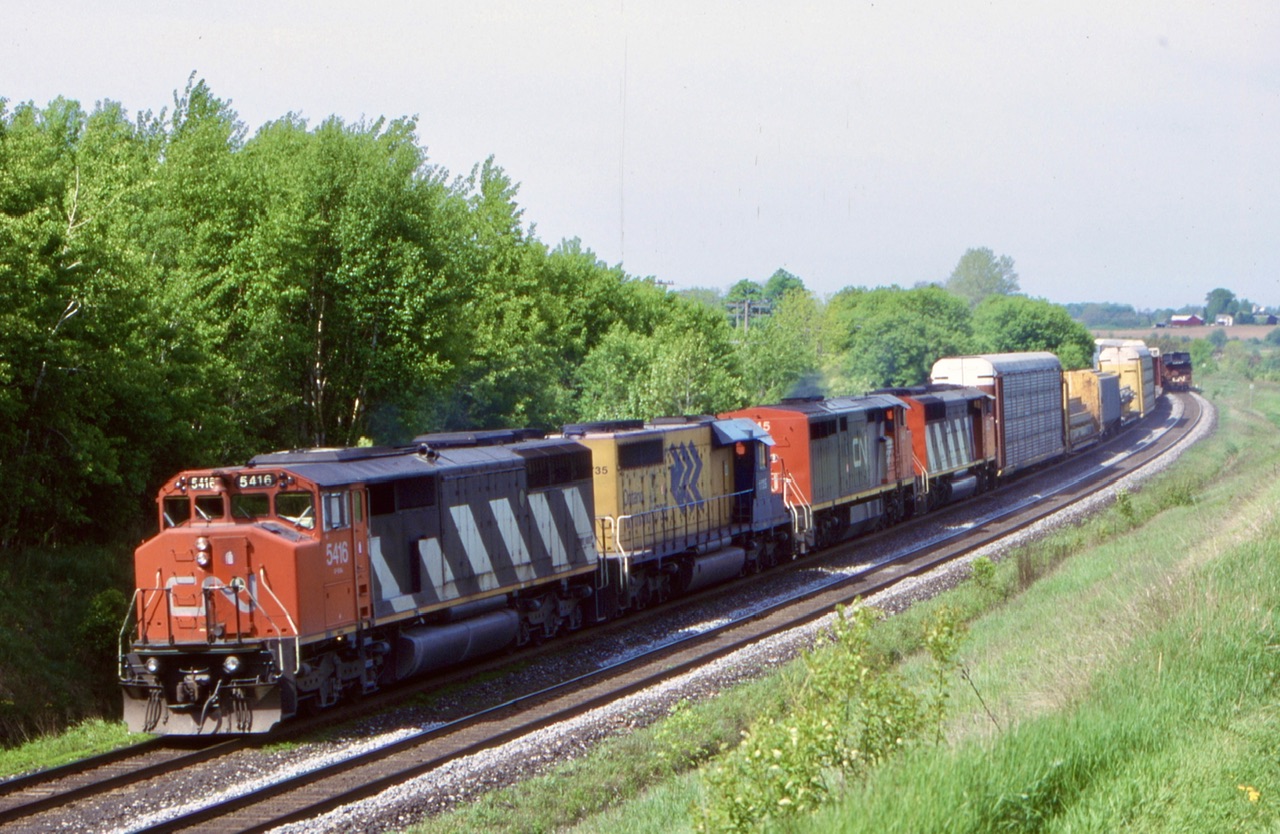 As much as I loved Railfaning this spot, it was always better for CP then CN. This shot took place about twenty minutes after the ballast train past us in the background. Unfortunately we had no idea this train was coming other then the few seconds that past after hearing the blast from its horn.  Here we have a SD50 and SD60 bracketing a Dash8 cowl along with a ONR SD40 as the round the bend east of Newtonville. It was nice back then as the INR power wandered often, sadly a rare change that these days.