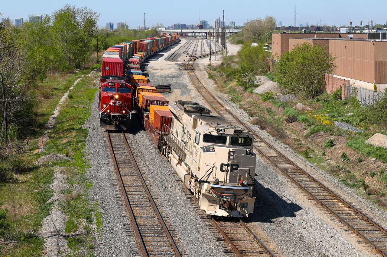 CP 7021 ‘Arid Regions Army Tribute Unit’ bringing up the tail end of CP 113-13, coming to a stop on north main track in Agincourt yard for trade off and refuel, CP 8149 leading CP 112 waiting patiently for the light at Neilson to depart.