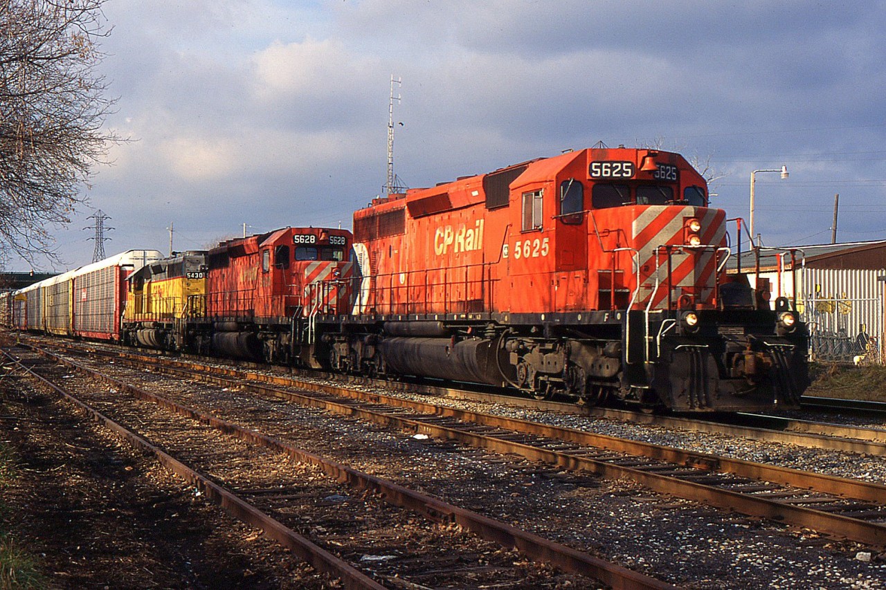 NS 328 with three CP SD40-2's CP 5625, CP 5628, and CP 5430 through Merritton on the CN Grimsby Sub during 1998.