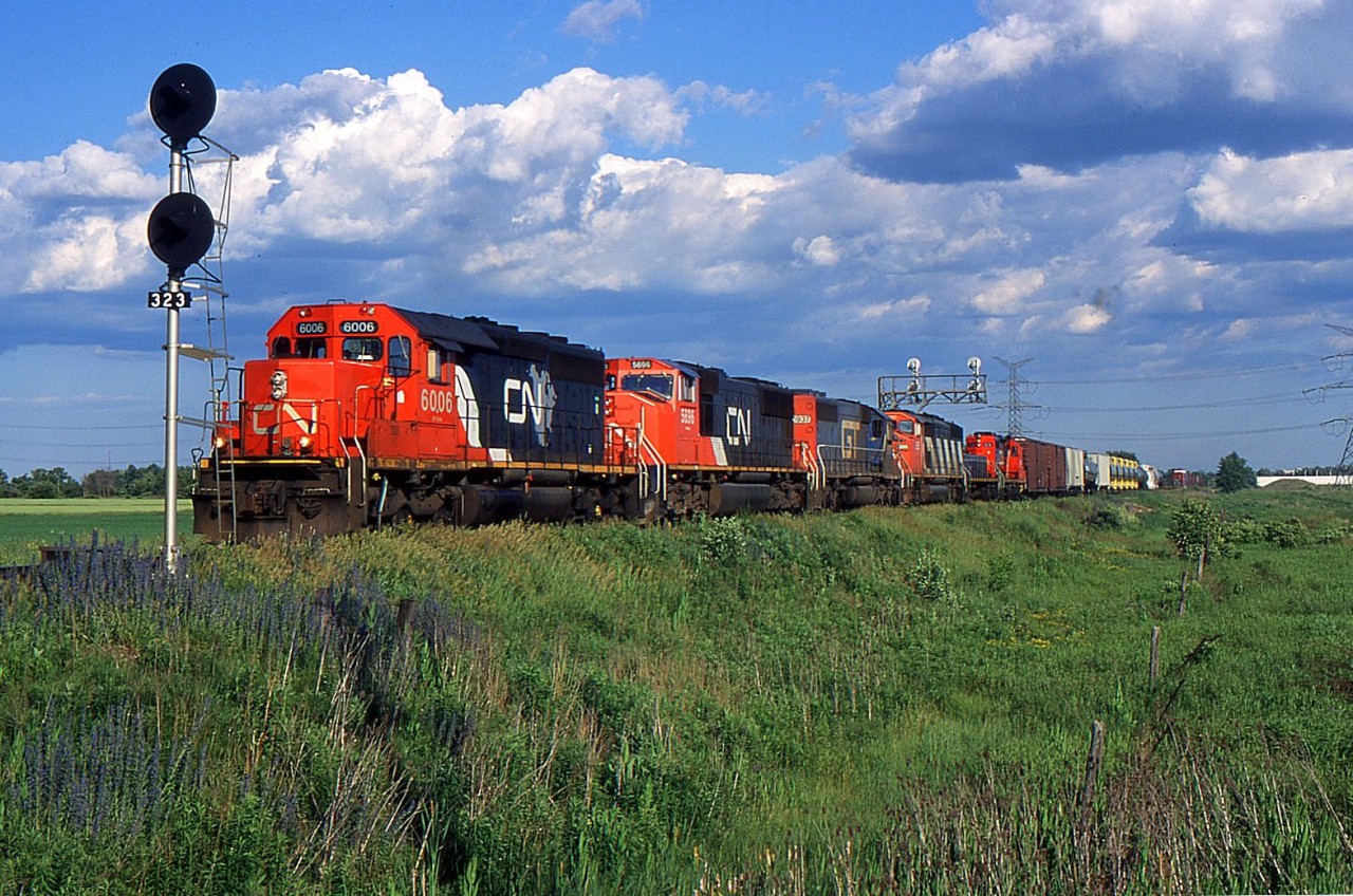CN Eastbound with CN SD40-3 6006 at Mansewood on the CN Halton Sub in June 1999.