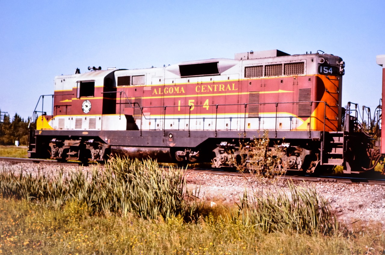 After a brief station stop, AC 154, an EMD GP7 built in March 1951 leads a small passenger train northbound out of Oba, ON in July of 1976. trailing the locomotive was a nice Algoma Central consist that included AC 74 steam generator unit, AC 201 express baggage, AC 209 express baggage, AC 422 coach, and, AC 424 coach. I was working in Oba at the time on a CN regional tie renewal gang and took the opportunity to walk across CN's yard and onto the ACR yard tracks to capture the movement as it continued its journey to Hearst, ON.