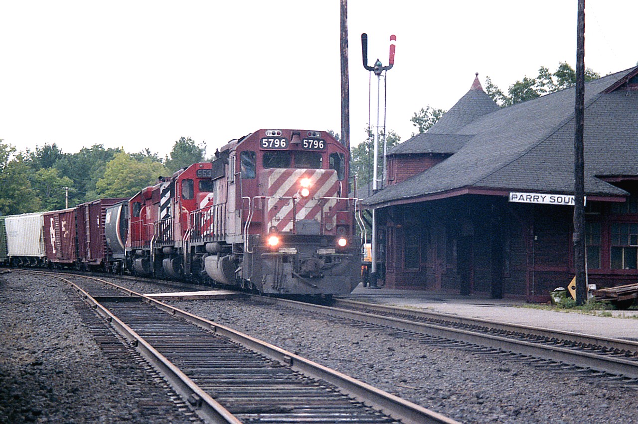 Another one of those days when the cloud and fog have rolled in off of Georgian Bay.  Didn't really matter. I would have been shooting right into the sun if it was out.  CP 5796, 5535 and 5921 are seen northbound past the old Parry Sound station on  a dull but very humid afternoon.  I've always liked this photo because of the Parry Sound station sign. It now hangs proudly in my garage.
