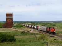 Eastbound general Merchandise 312 passes an abandoned elevator and crosses Alberta highway 41 just a few miles west of the Saskatchewan border