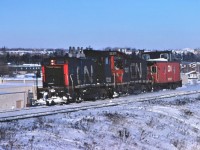 A pair of CN SW1200RS units from class GR-12f built in 1956 rush back to Toronto Yard with a van hop movement.  The units are 1228 and 1237.  The units may be from the same order, but there are many differences.
1228: small number board numbers; grey spark arresters; low CN symbol; low cab number.
1237: large number board numbers; silver spark arresters; high CN symbol; high cab number.

Hard to believe this photo was taken 45 years ago.  
