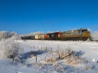 While Edmonton is shrouded in a think layer of ice fog, just outside of the city is enjoying beautiful sunny weather.  A 40251 30 gets under way through a hoar frost covered landscape with CN 2776 on the point.