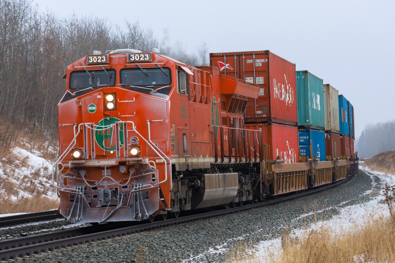 Q 19991 12 highballs through Stony Plain with a frost covered heritage unit on the point