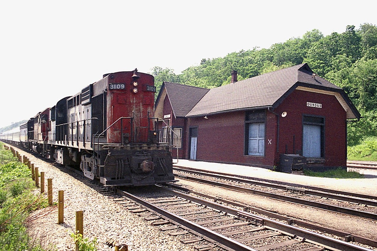 One of the drawbacks about hanging out at the old Dundas station was the fact eastbound trains in the late
afternoon posed a terrible sun angle for shooting.  But, what the heck, might as well kill the last couple of hours of the day while here.  In about as harsh as shadows can get, CN 3109 and two other units are caught running eastbound. I missed the last two numbers as well as not recording the train number, but looking at the sun angle here I am going to guess it was #76.