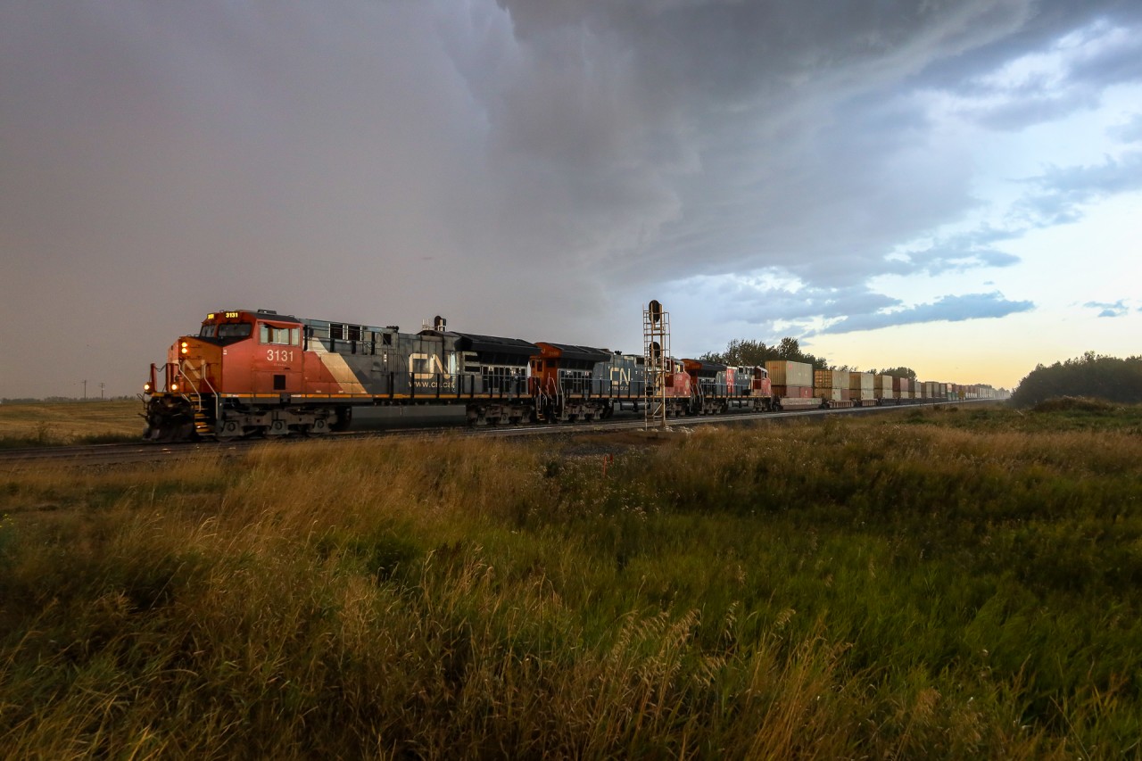 Toronto to Vancouver hotshot Z 11131 05 departs Edmonton, as the skies open with a brief, but strong September Thunder Storm.