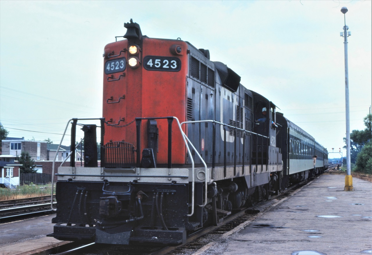 CN train 673, the "Budd cars" from Toronto, have arrived at North Bay and are waiting to head Transfer Yard to be turned.  This day, the train was conventional with freight GP9 4523 doing the honors.  Former Crusader coach 302 brings up the tail end of the train.