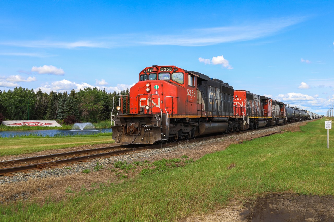 A trio of SD40-2W's rolls past the DOW Chemicals sign, on the old mainline through Fort Saskatchewan.